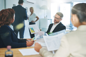 Success is the product of teamwork. Shot of corporate colleagues working together in their office.
