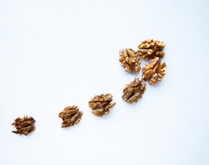 Walnut scattered on a white background. Peeled walnut kernels