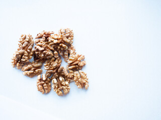 Walnut scattered on a white background. Peeled walnut kernels
