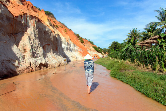 A woman in the red canyon in Mui Ne