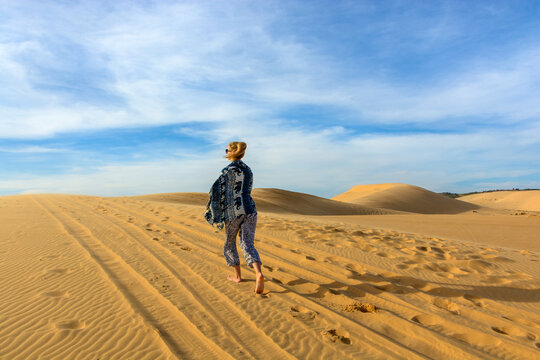 A woman walking through the desert