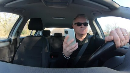 People, travel and technology. Man talking on mobile telephone. Driver using cell phone, driving car on the street, using smartphone for conversation. Danger and risk on the road