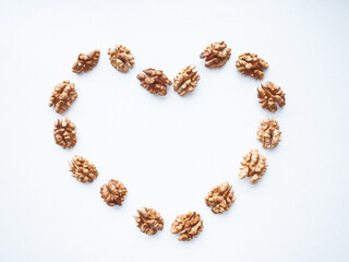 Heart on a white background laid out from walnuts