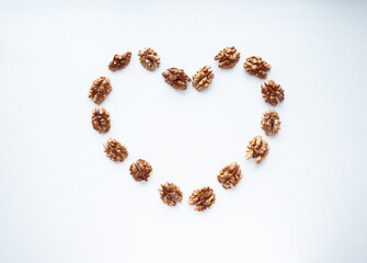 Heart on a white background laid out from walnuts