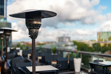 Stainless stand up outdoor gas heater in cafe.