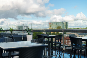 Rooftop cafe interior with table and chairs.