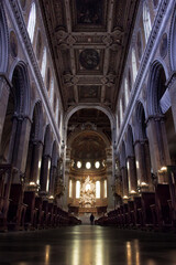 interior of a basilica, shot from low angle and a person is walking in distance