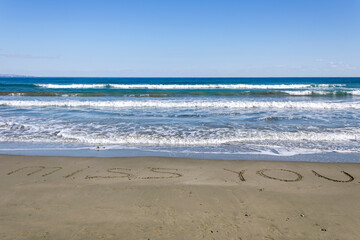 Fototapeta na wymiar Sandy beach with words Miss You