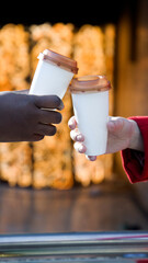 hands with cups of coffee colliding