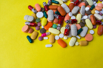 various medicines on yellow background.