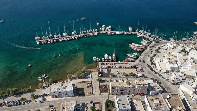 Aerial drone photo of picturesque village of Adamantas main port a natural calm sea bay and safe anchorage of yachts and sail boats in volcanic island of Milos, Cyclades, Greece