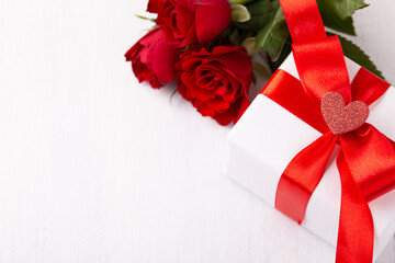 White gift box red ribbon and roses on white background, Valentine's or Mother's day card template