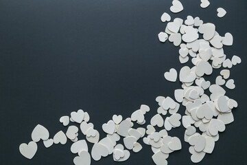 white wooden hearts on a black background