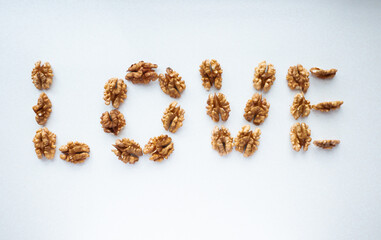 word love laid out from walnuts on a white background