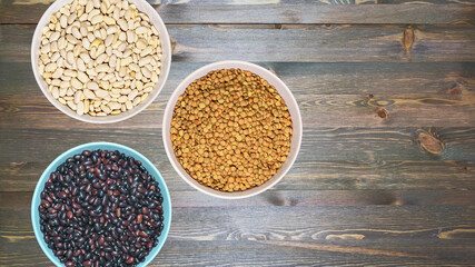 three ceramic bowls with various healthy grains. The concept of natural healthy food. Grains beans close up