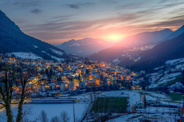 Snowy mountain village at sunset
