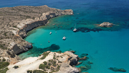 Obraz premium Aerial drone photo of tropical exotic paradise bay with deep turquoise sea forming a blue lagoon visited by luxury yachts and sail boats