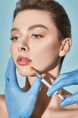 Lip augmentation procedure. Syringe with lips filler near beautiful woman's mouth, injections for...