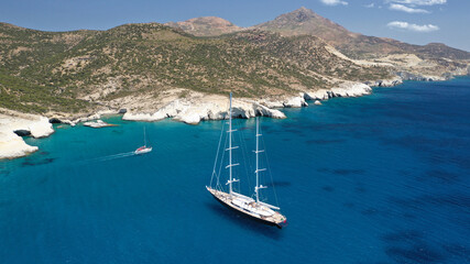 Aerial drone photo of Kleftiko a beautiful scenic white volcanic rock formation bay visited by sail boats and yachts with turquoise crystal clear sea and caves, Sea Meteora of Greece, Milos island