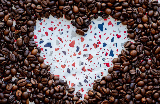 heart shape from coffee beans. beautiful high quality wallpaper for valentine's day. celebrating love. little colorful particles on paper. ready for greeting. free space for text.