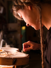 woman luthier working on a wooden handmade classic violin - obrazy, fototapety, plakaty