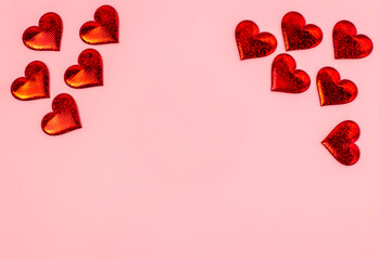 red hearts on pink background with a place for the text, top view, Valentine's Day is the holiday of lovers.