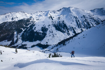 Fototapeta na wymiar Person in snow on skitour on the mountain top of Mareitkopf in Alpbachtal in Austria.