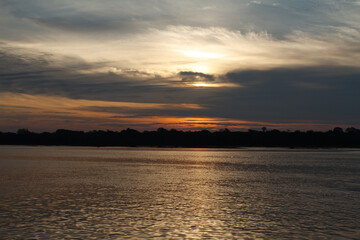 A sunset in a river of the amazon jungle, in Peru