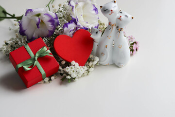 gift concept for valentine's day. gift box, red heart and spring flowering branches