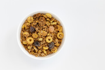 crunchy granola in bowl isolated on white background