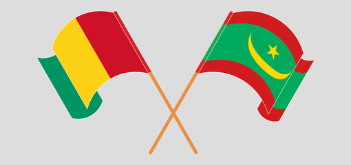 Crossed and waving flags of Guinea and Mauritania