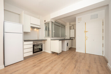 Semi-furnished kitchen in a one-room studio with wooden floors