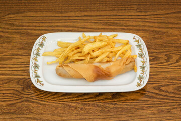 German sausage menu wrapped in crispy biscuit with fries garnish