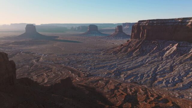 Road trip concept to Utah and Arizona, USA travel background with copy space 4K. Monument Valley landscape on sunny winter day. Scenic panorama world famous nature park with view from western movies