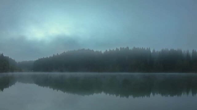 Time lapse video of Savsat Karagol Black lake in Eastern Black Sea region during morning evaporation. Savsat Karagol lake is a large trout lake in the forest in Artvin, Turkey