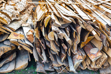 Industrial timber wood for carpentry, building or repairing, lumber material for roofing construction. stack natural chopped dry trunks, Fire logs prepared for winter, ready for burning