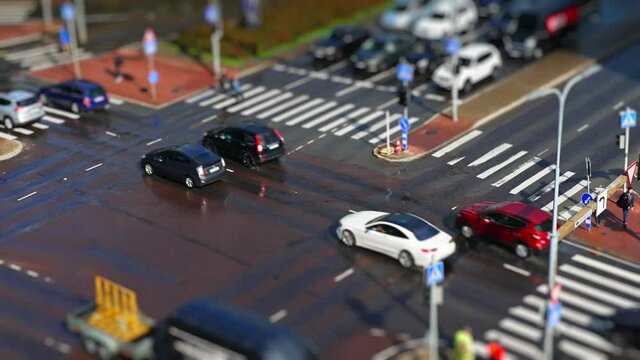 Crossroad with people and cars. Miniature effect.