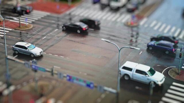 Crossroad with people and cars. Miniature effect.