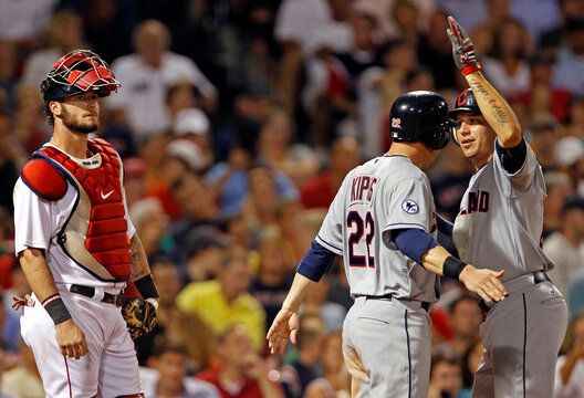 Red Sox' Saltalamacchia looks away as Indians' Cabrera celebrates his second two-run home run of the game with teammate Kipnis during their MLB American League baseball game in Boston