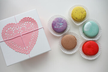gift concept for valentine's day. gift box with colorful macaroons, red heart and postcard for text 