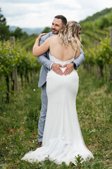 Wedding concept bride and groom man and woman kissing in the field celebrating happy after the marriage ceremony full length