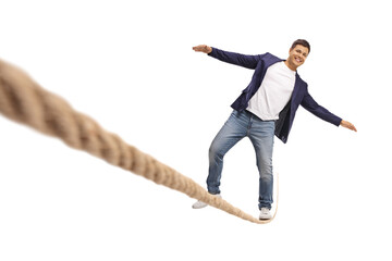 Full length portrait of a smiling young man walking over tightrope - Powered by Adobe