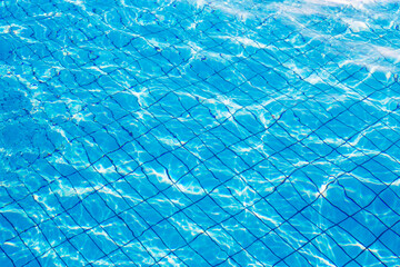 Turquoise  water background. Blue swimming pool color . Hotel sport ground top view. Healthy recreation  spot.