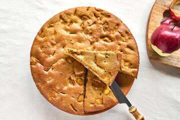 Homemade apple cake Charlotte, american sponge apple pie with walnuts and ripe red apples on the...