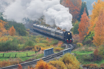 Retro steam train moves at autumn morning. Karelia.
