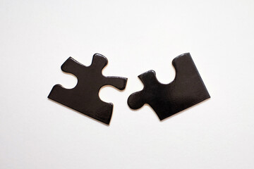 Two black puzzles on a white background. Puzzle for the development of children's intelligence. The...
