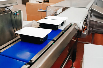 modern poultry processing plant.Meat processing in food industry.Packing of meat slices in boxes on a conveyor belt.Line for the production of semi-finished meat products.