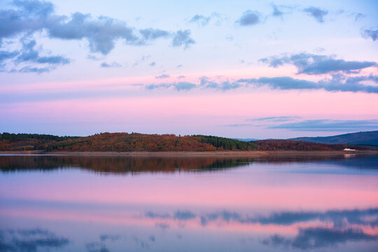 Autumn landscape at sunset with pink color sky