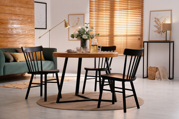 Stylish apartment interior with dining table and other furniture
