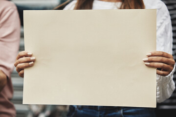 It's a matter of choice. Cropped shot of an unrecognizable woman holding a sign while taking part...